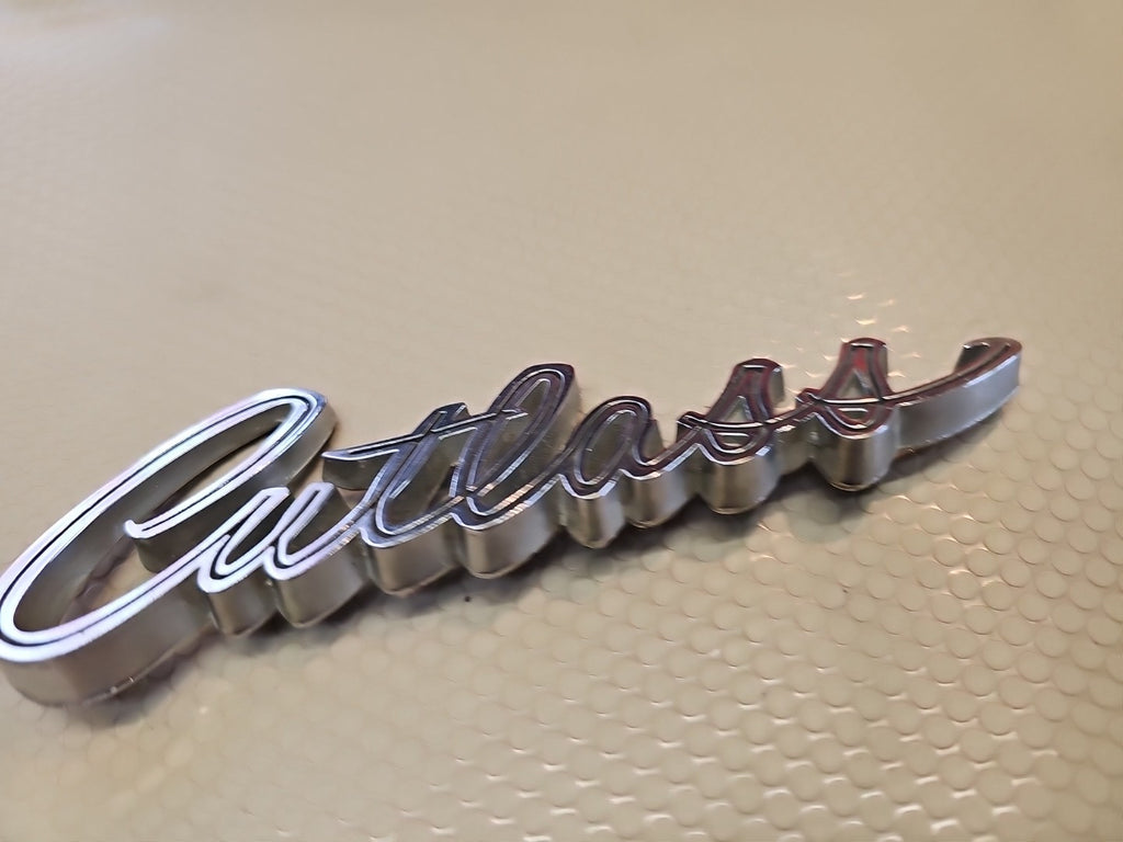 Original 1969 Oldsmobile Cutlass script emblem 399503 - Vintage OEM Badge